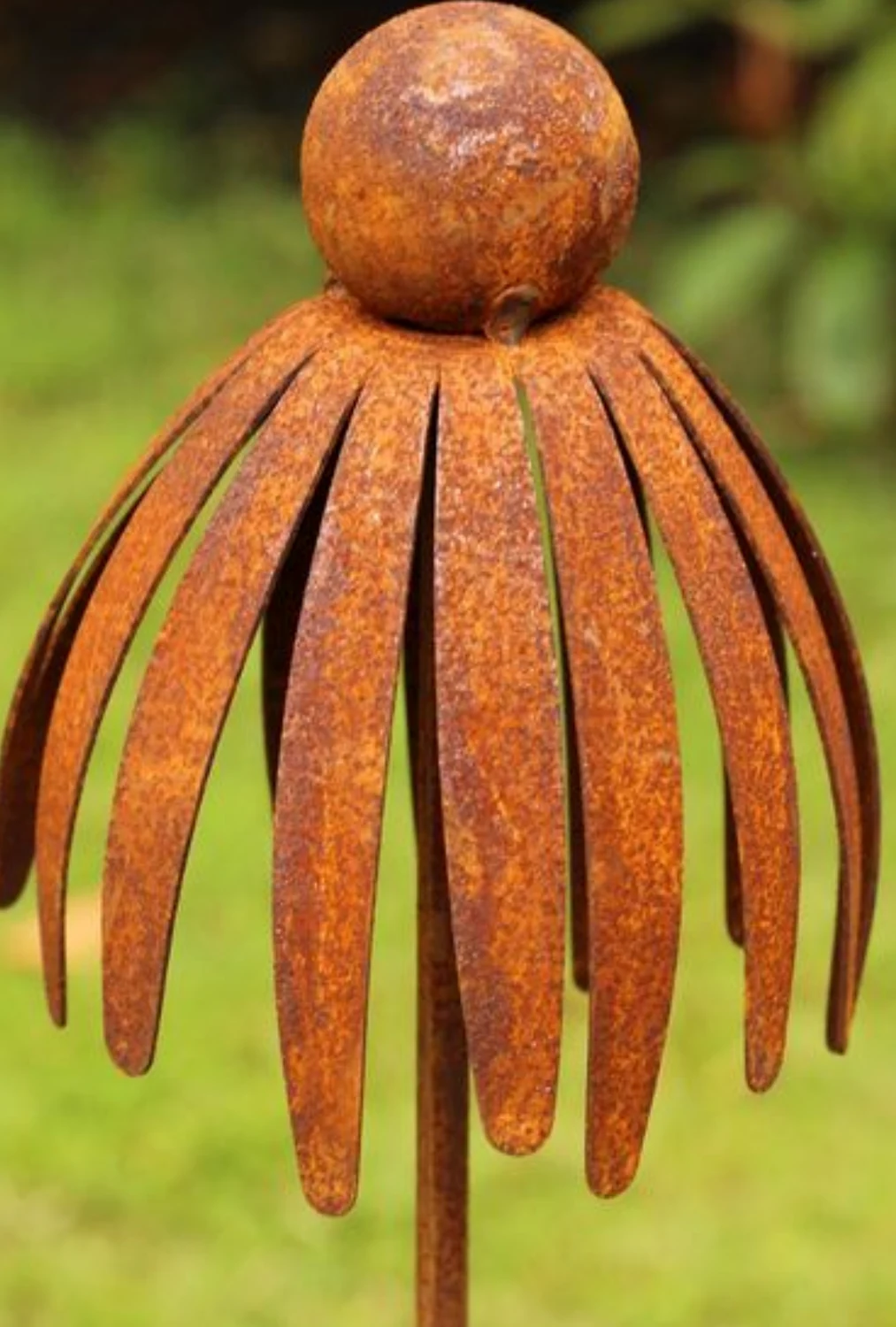 Rust colored metal seedhead garden sculpture